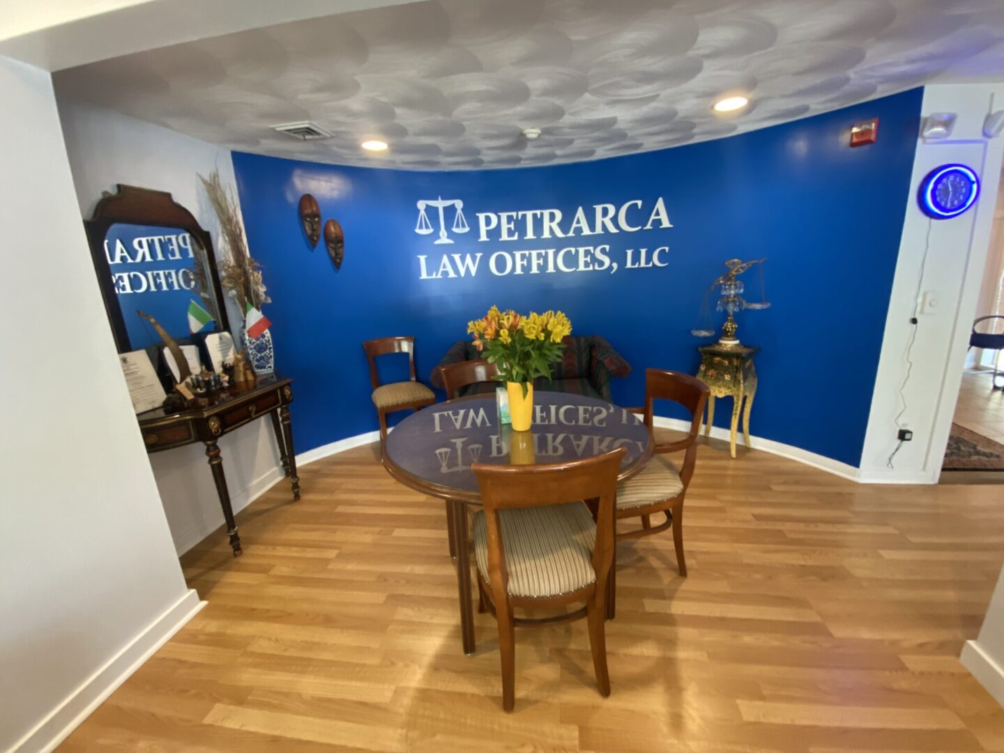 A table with flowers in front of the words petracca law offices, llc.