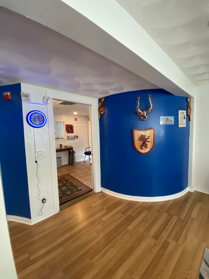 A blue wall in the center of a room.